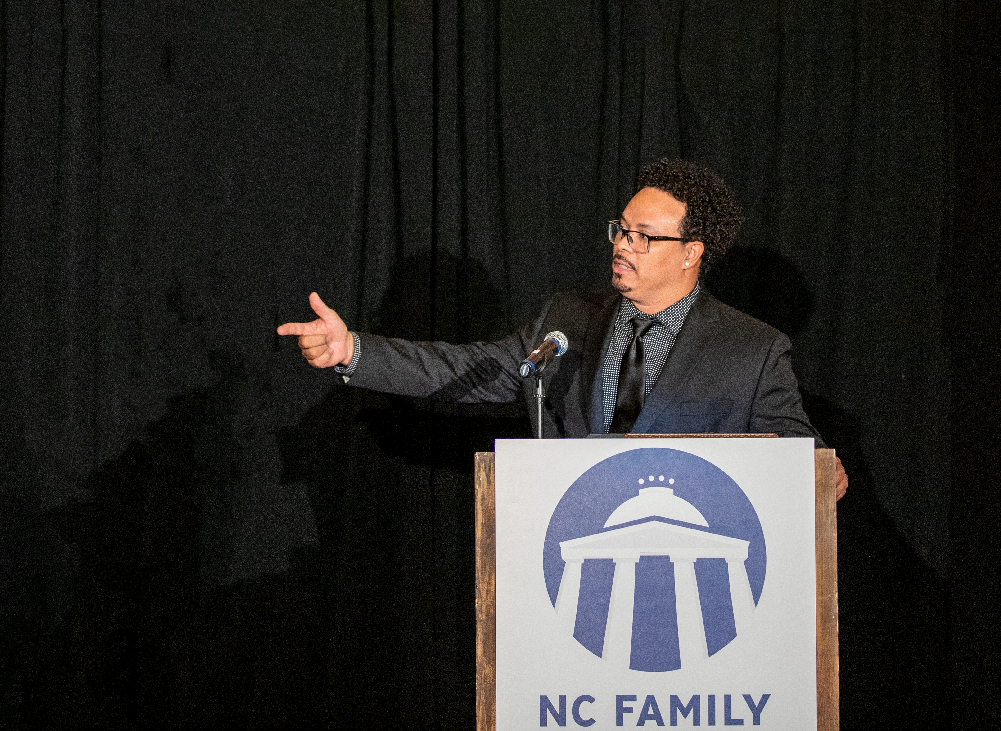 Ryan Bomber speaking behind a lectern at NC Family's Winston-Salem Dinner