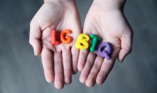 Hands holding LGBTQ Letters