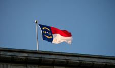 North Carolina Flag flying over concrete wall