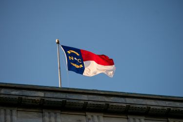 North Carolina Flag flying over concrete wall