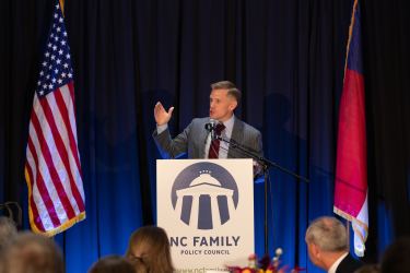 Joseph Backholm speaking at a lecturn at NC Family's Winston-Salem Dinner