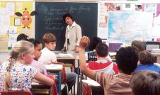 Students sitting at desks in a classroom at school