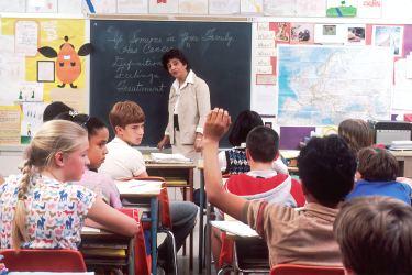 Students sitting at desks in a classroom at school