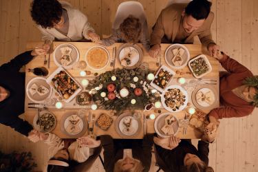 Family seated around a dinner table at christmas