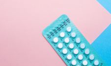 birth control pills on pink and blue background