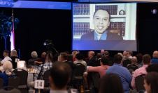 Dinner Attendees watching Roger Severino on a screen